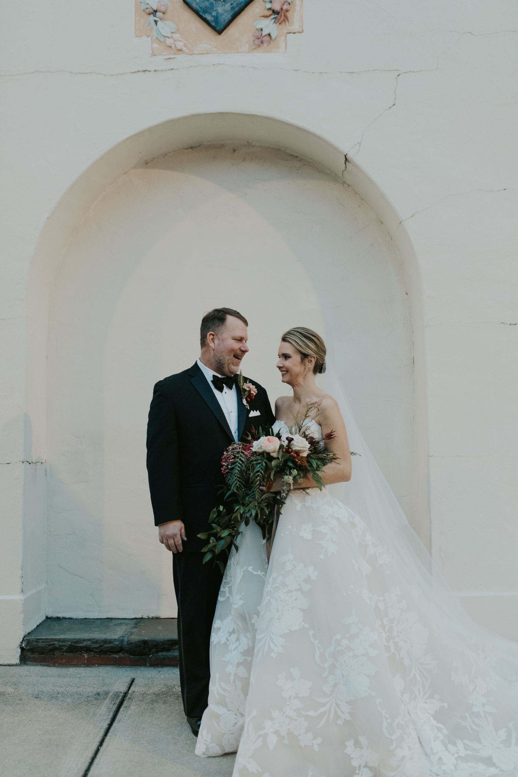 bride and groom at rainy winter wedding at Il Mercato in New Orleans