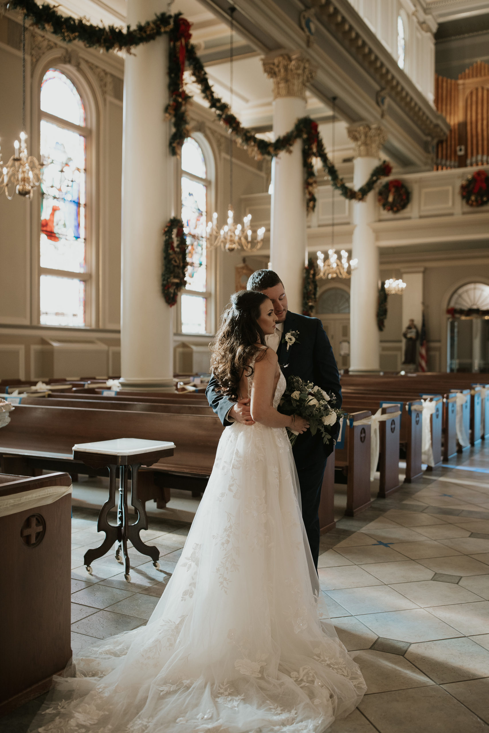 bride and groom in st. joseph's co-cathedral church embracing