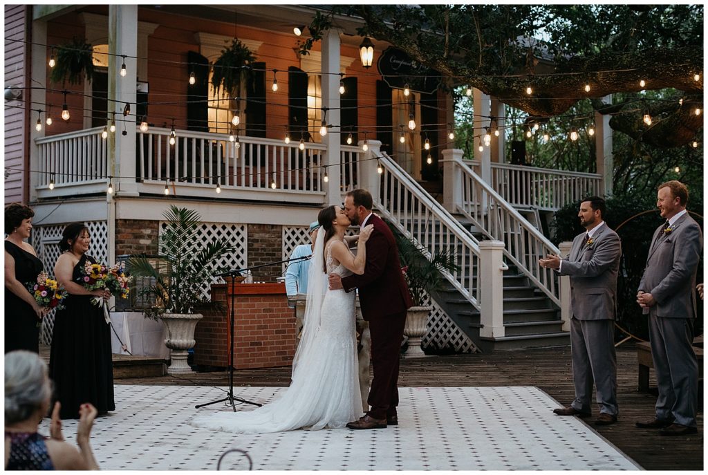 The bride and groom share their first kiss at compass point events wedding