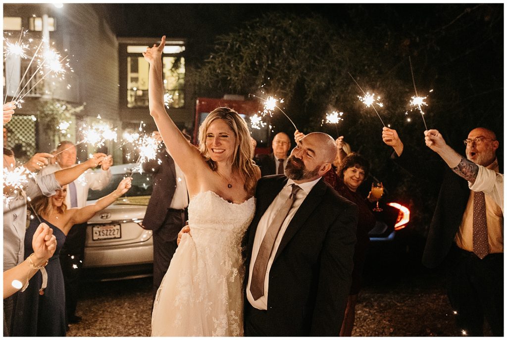 An intimate backyard wedding ends with sparklers