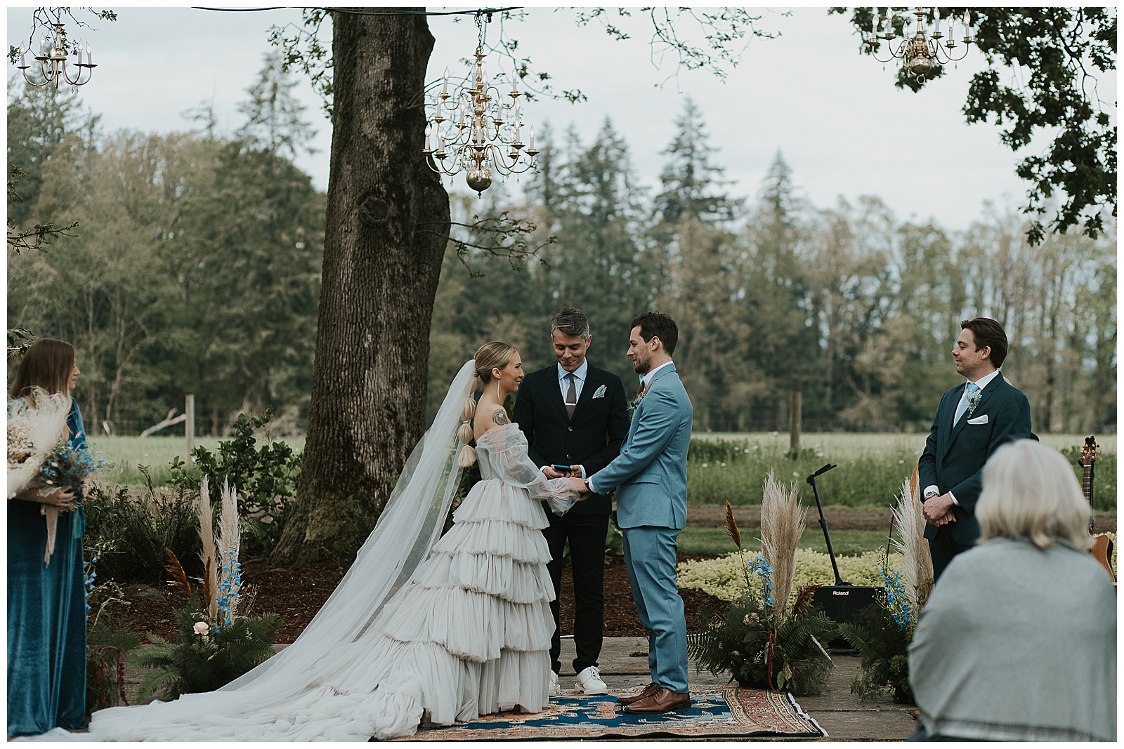 A couple gets married under trees at a wedding on Oregon coast