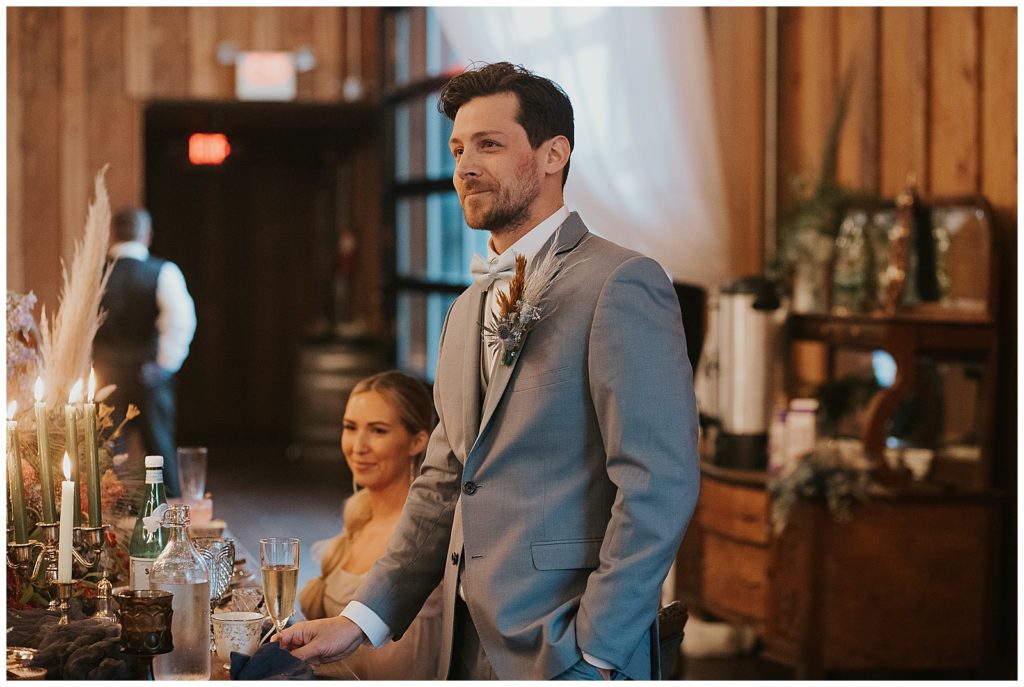 A groom stands at the reception for his wedding on Oregon coast