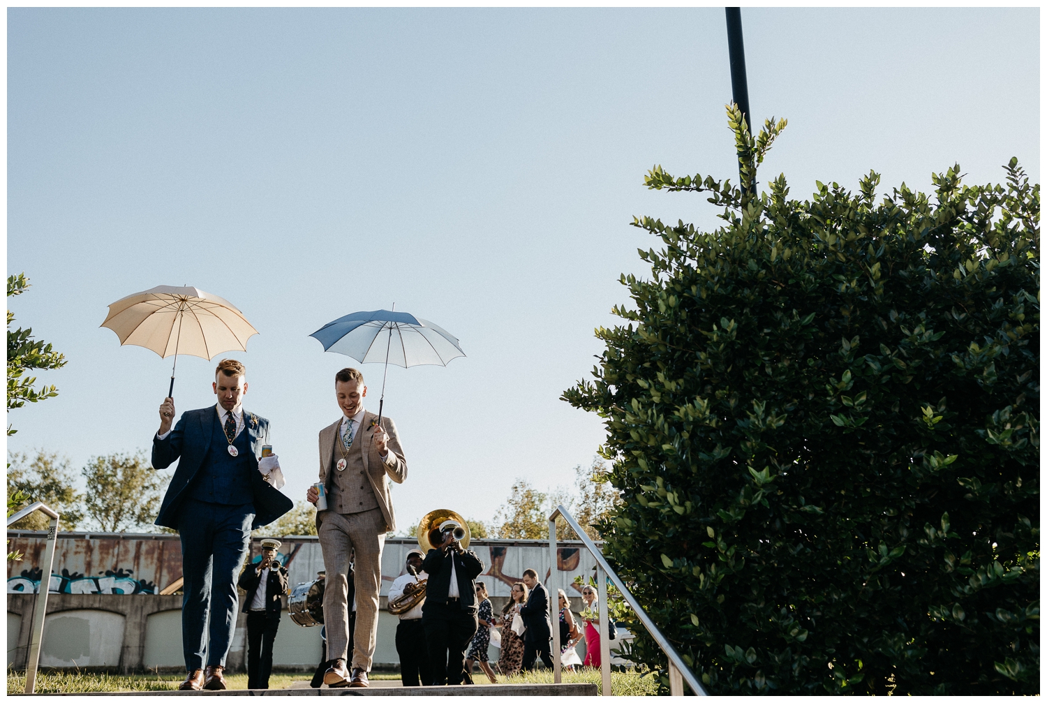 The grooms lead the second line to the Tigermen Den wedding reception