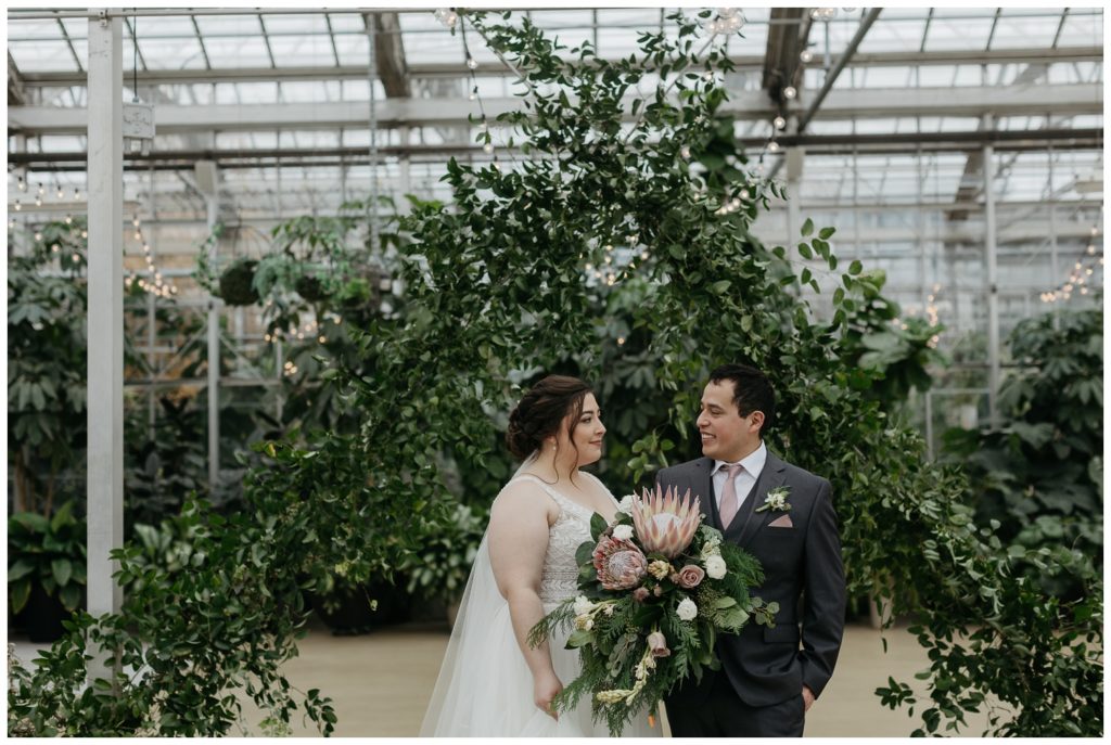 The couple talks about the wedding timeline in the greenhouse
