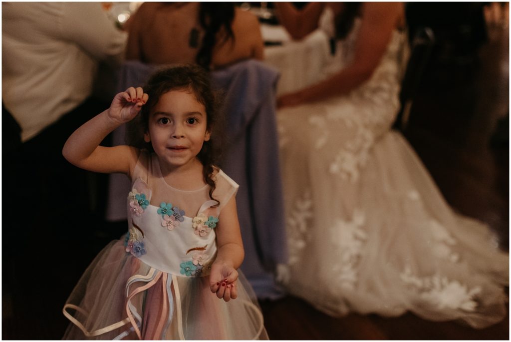 child smiles at wedding reception