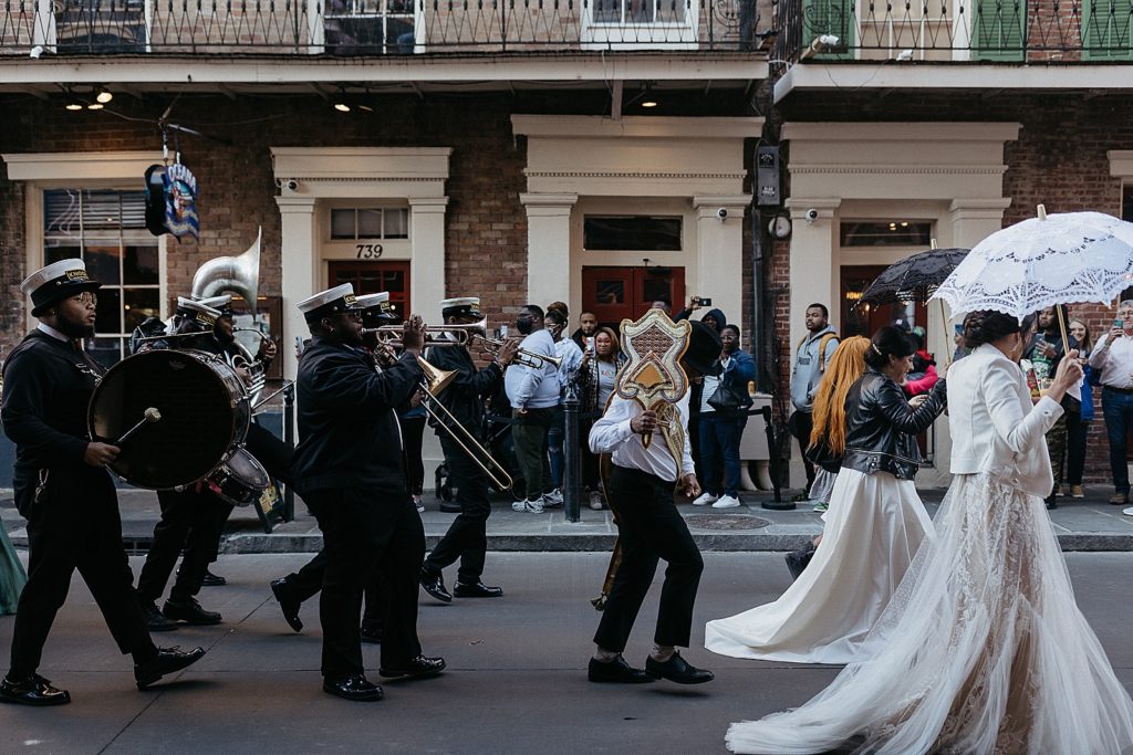 A New Orleans wedding parade passes by.