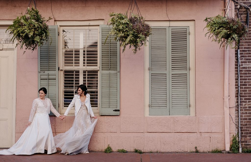 Two women walk towards their French Quarter wedding