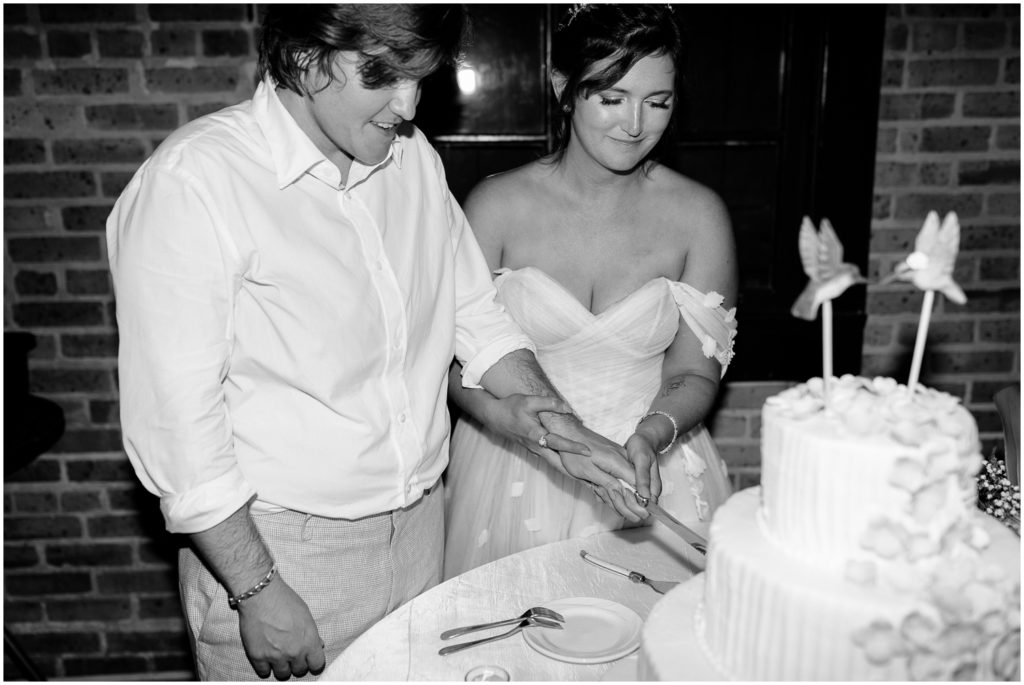Britt and Em cut their wedding cake.