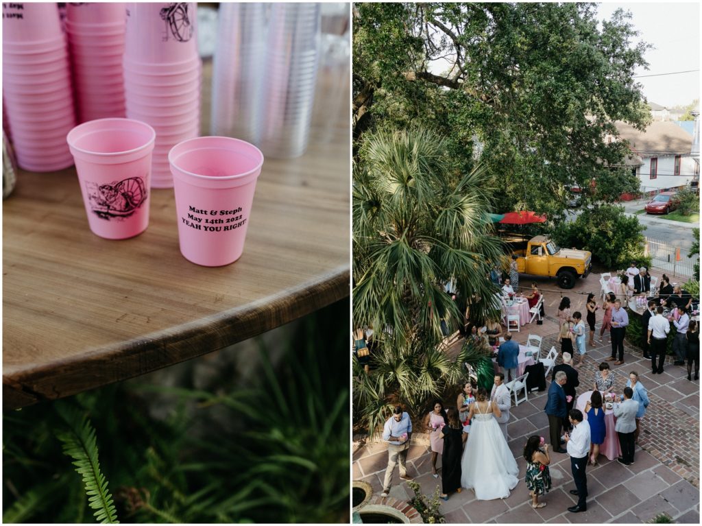 Pink cups sit on a custom wood bar beside ferns.