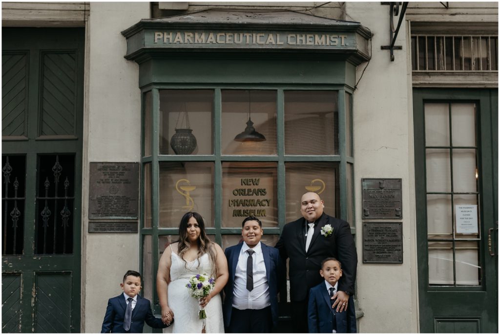 A family stands in front of the Pharmacy Museum.