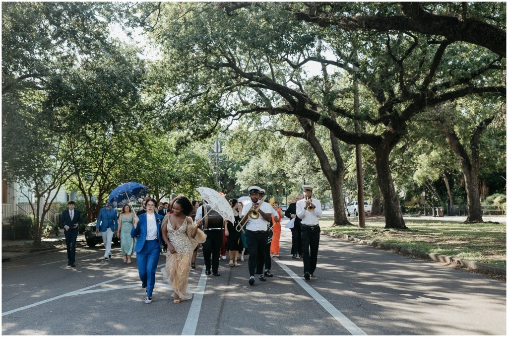 A New Orleans wedding parade goes down the street.