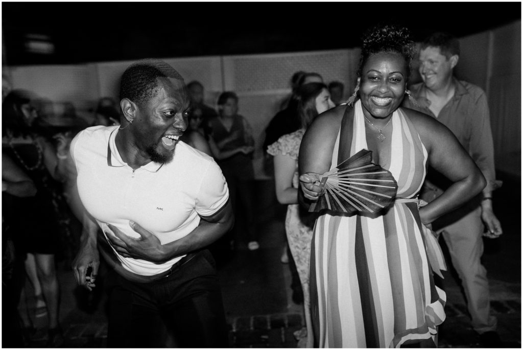 Wedding guests dance side by side.