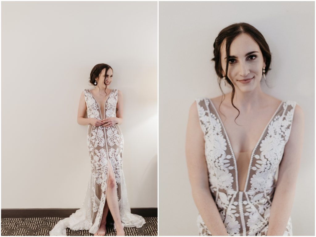 Marissa stands against a white wall in her wedding dress before her rainy wedding.