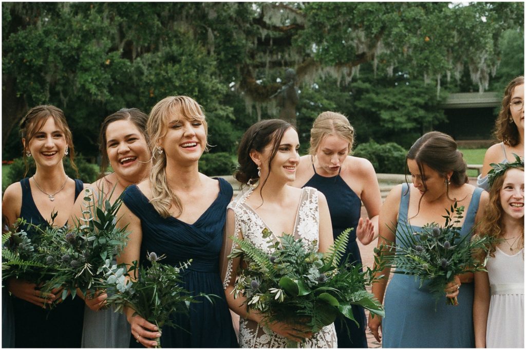 Marissa's bridesmaids gather around her with their wedding bouquets.