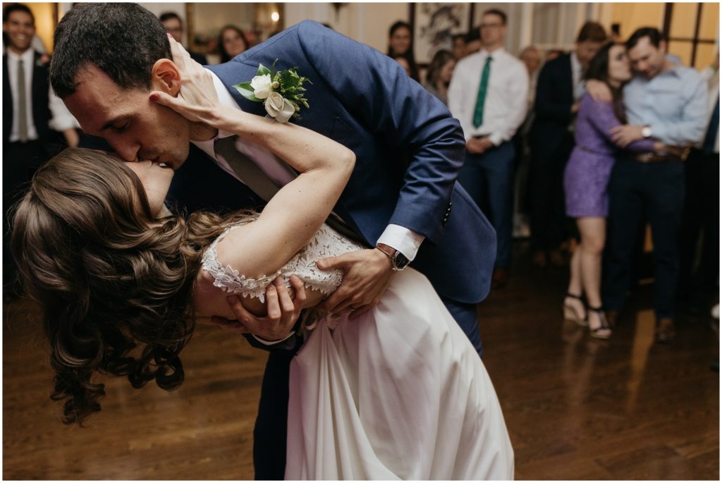 A couple kisses on the dance floor during the first dance.