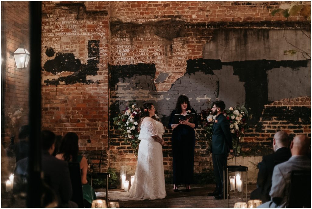 A couple gets married surrounded by candles in the Ace Hotel.