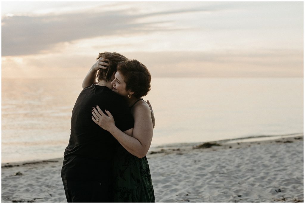 A couple embraces after their New Orleans proposal at Fontainebleau state park.
