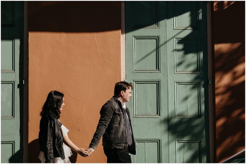 Newly weds walk through a patch of sunshine on a French Quarter sidewalk.