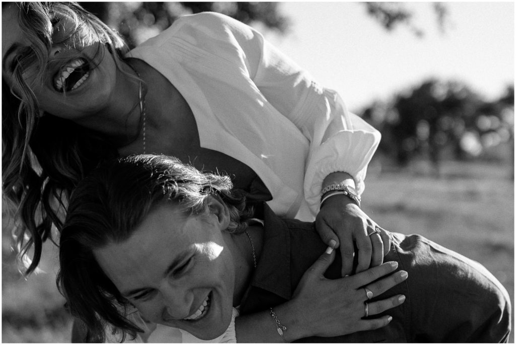 Jacob and Jeannie lean over laughing during their engagement session.