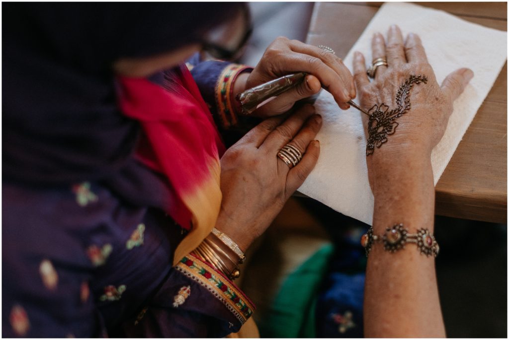 An artist applies henna to a woman's hands during a Mehndi party in New Orleans.