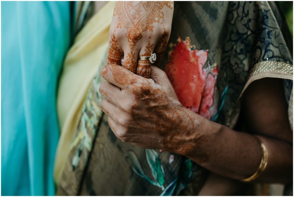 Tiffany's grandmother holds her hand while they where their traditional saris.