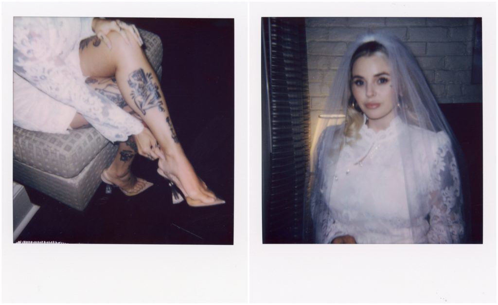 A bride poses for Polaroid portraits in her hotel room.