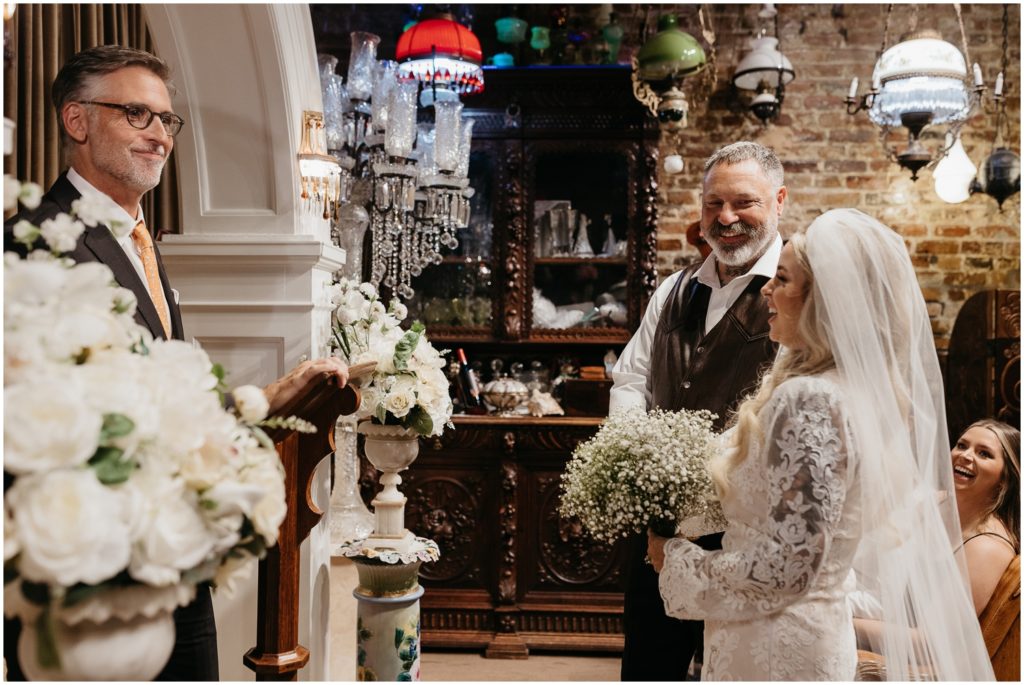 Jake and Nicole laugh at Reverend Tony at the altar of the French Quarter Wedding Chapel.