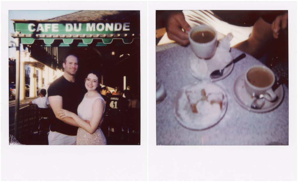 Lauren and Eric embrace in front of the Cafe Du Monde awning.