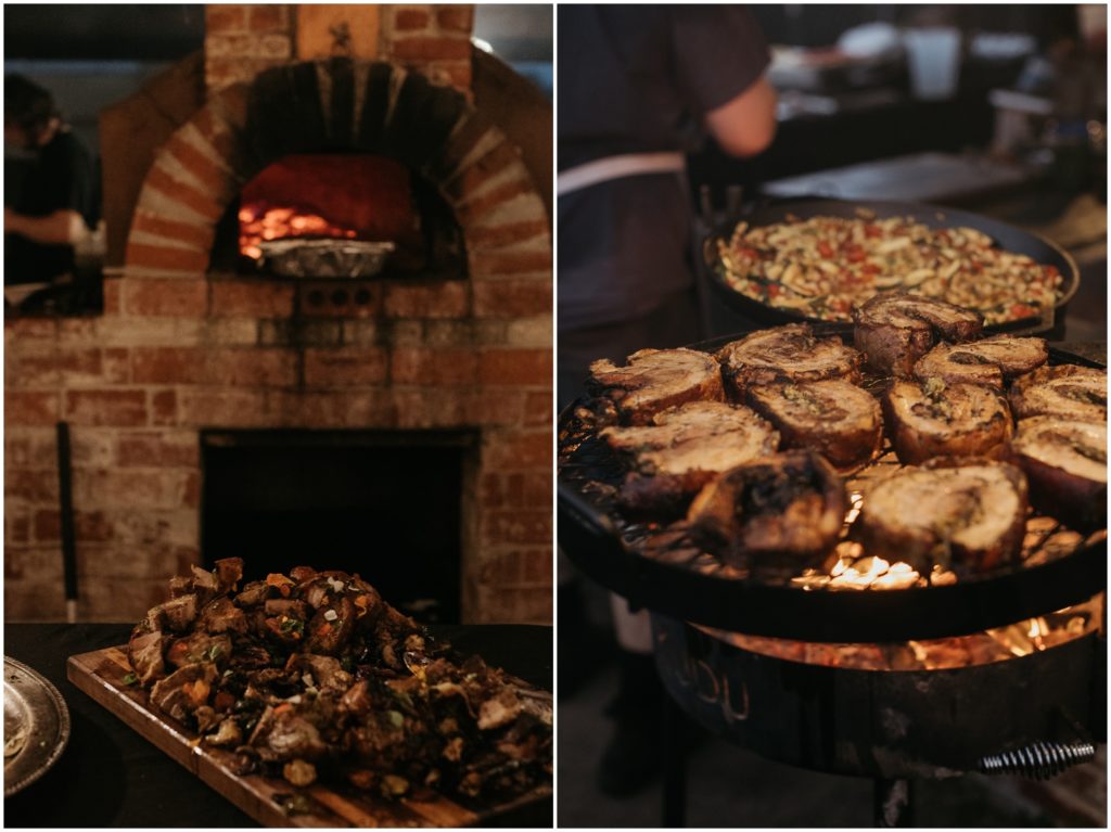 A chef puts food into a wood-fired stove.