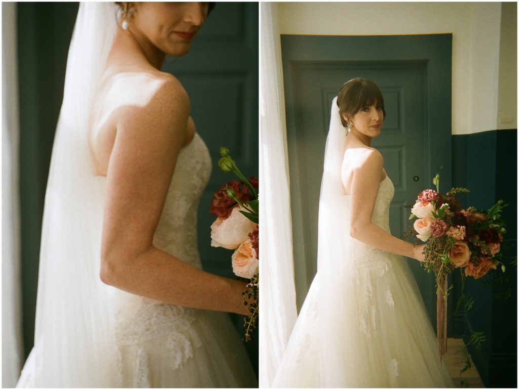 A bride looks over her shoulder beside a window before a Hotel Peter and Paul wedding.