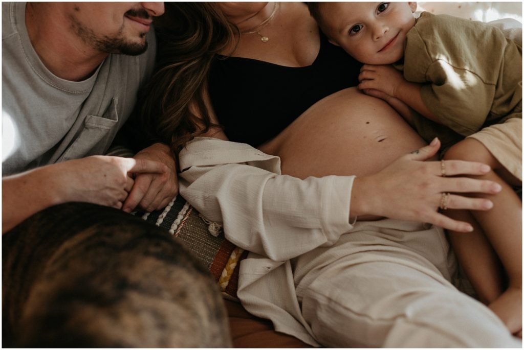 The family cuddles in close during the maternity session.