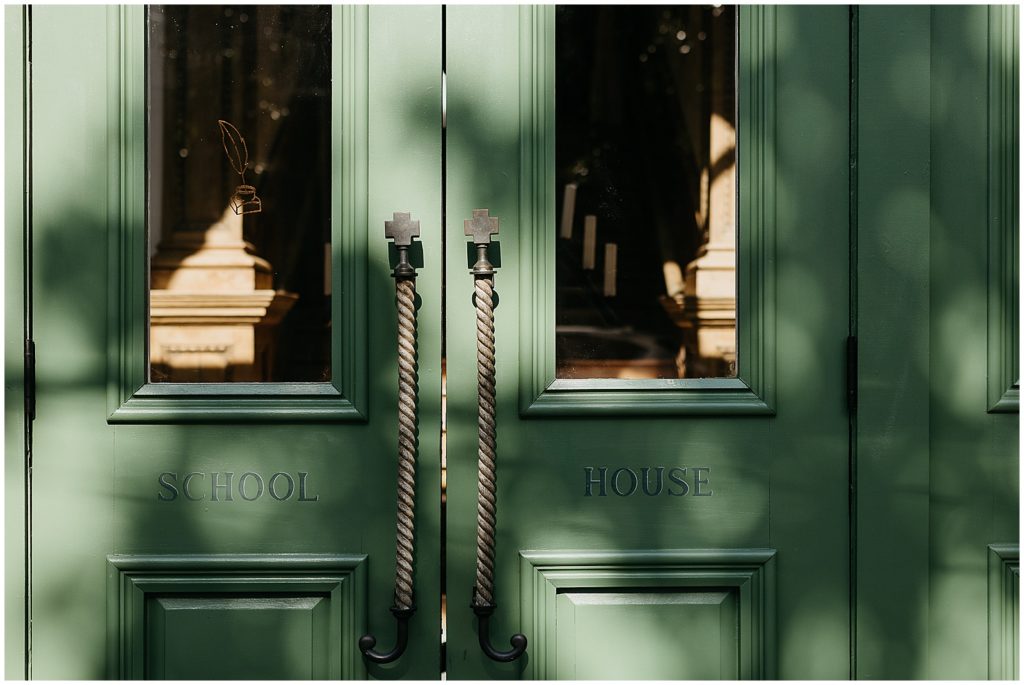 Historic green doors read "School House."