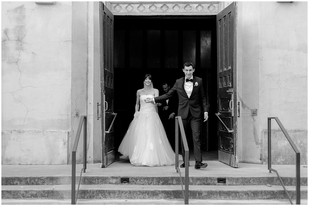The bride and groom exit the New Orleans wedding venue.