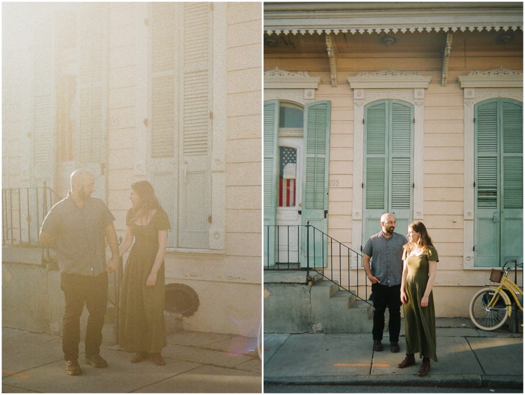 A man and woman stand in the sunshine in front of a pink and blue French Quarter house.