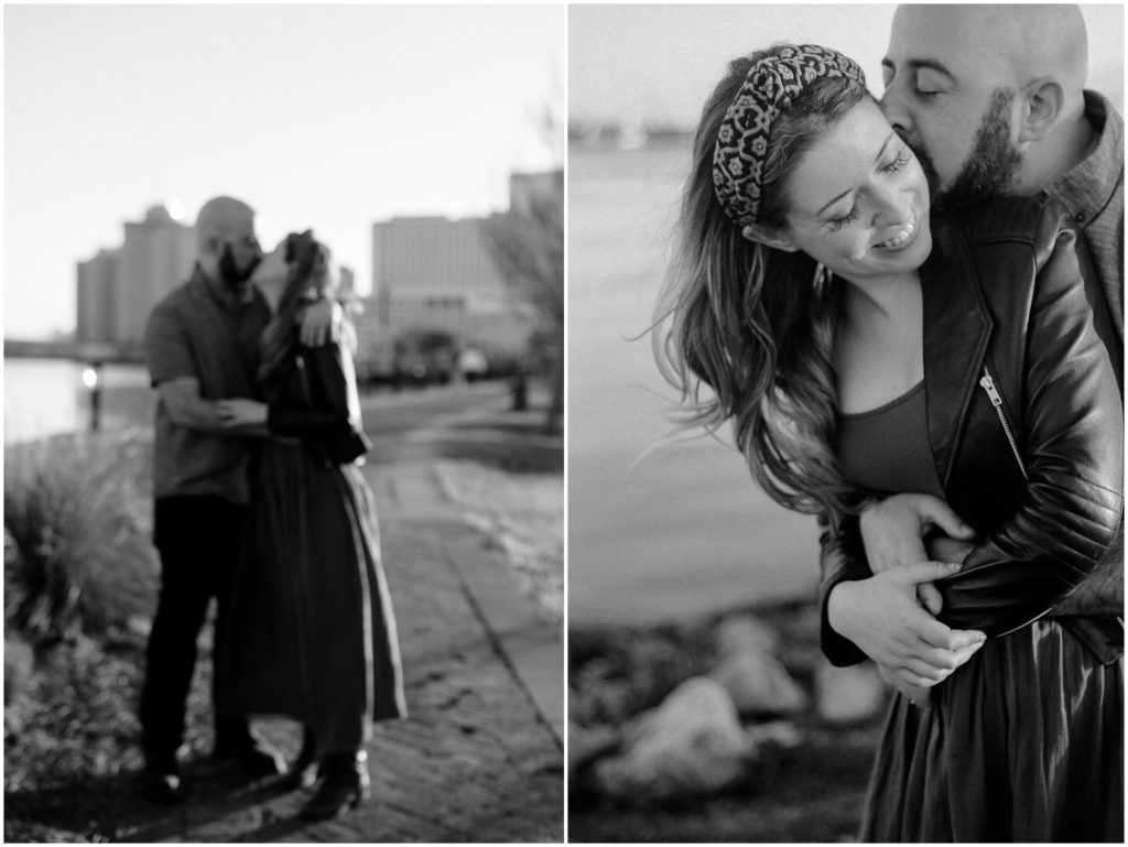 Omar hugs Anastasia from behind and kisses her cheek during a creative engagement photoshoot.