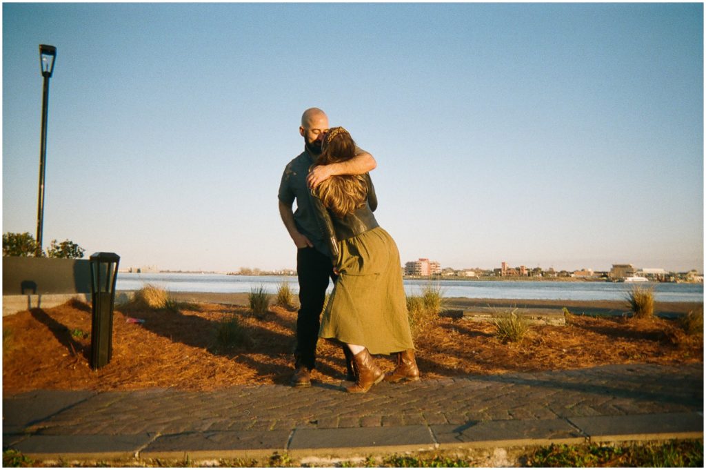 Anastasia leans on Omar as they walk along the levee in a creative engagement photoshoot.