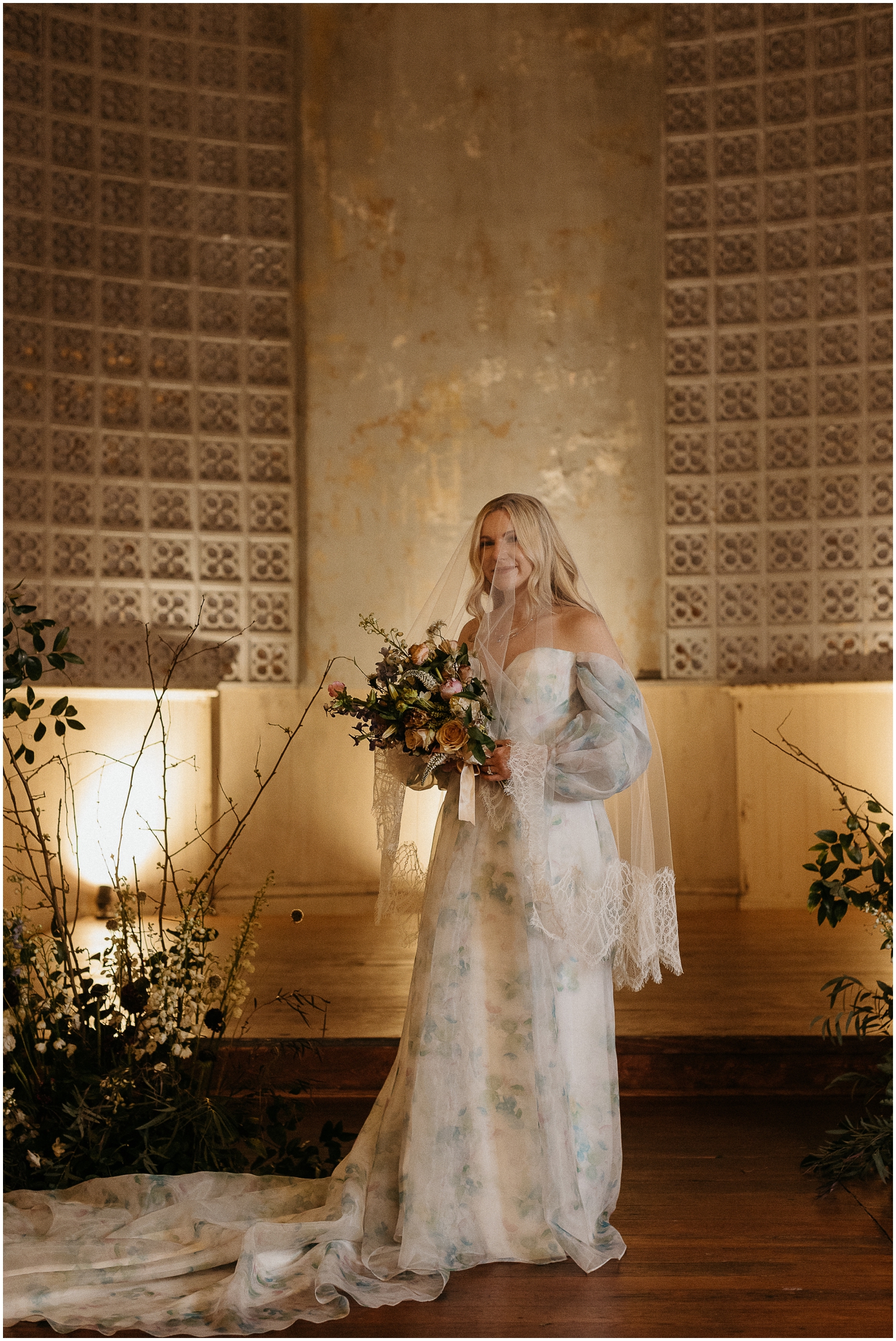 A bride poses with her bridal bouquet in Hotel Peter and Paul for editorial wedding photography.
