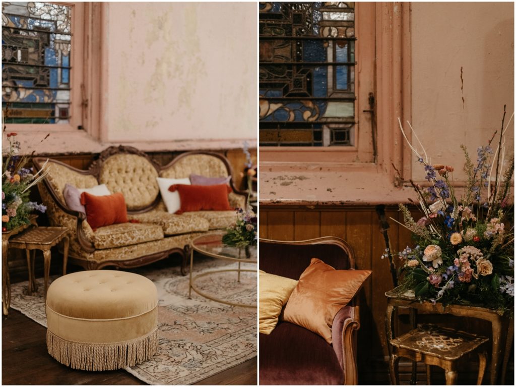 Vintage couches and floral arrangements decorate a hotel foyer.
