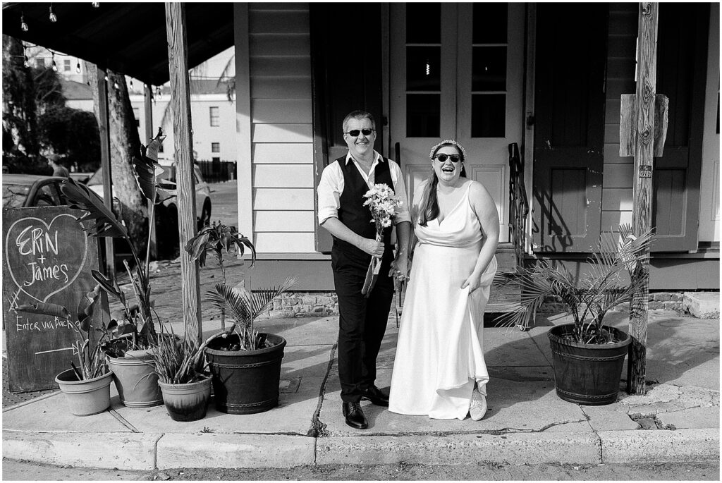 A bride and groom wear sunglasses outside Tigermen Den.