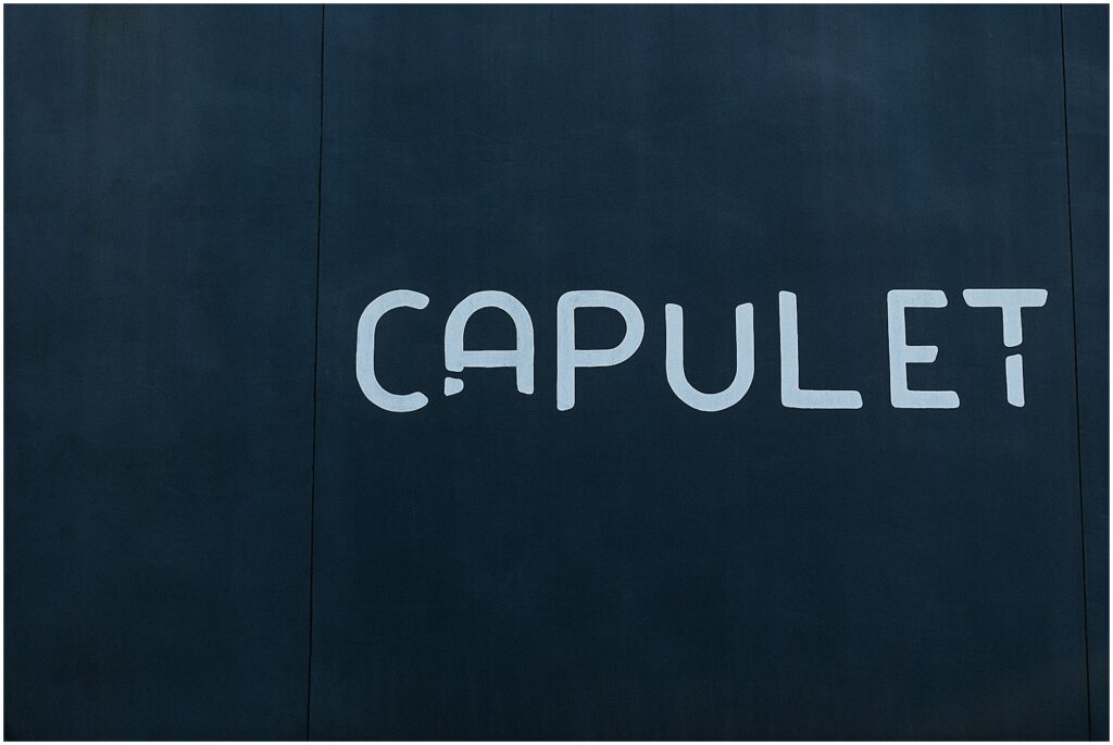 A blue sign with white letters reads "Capulet"
