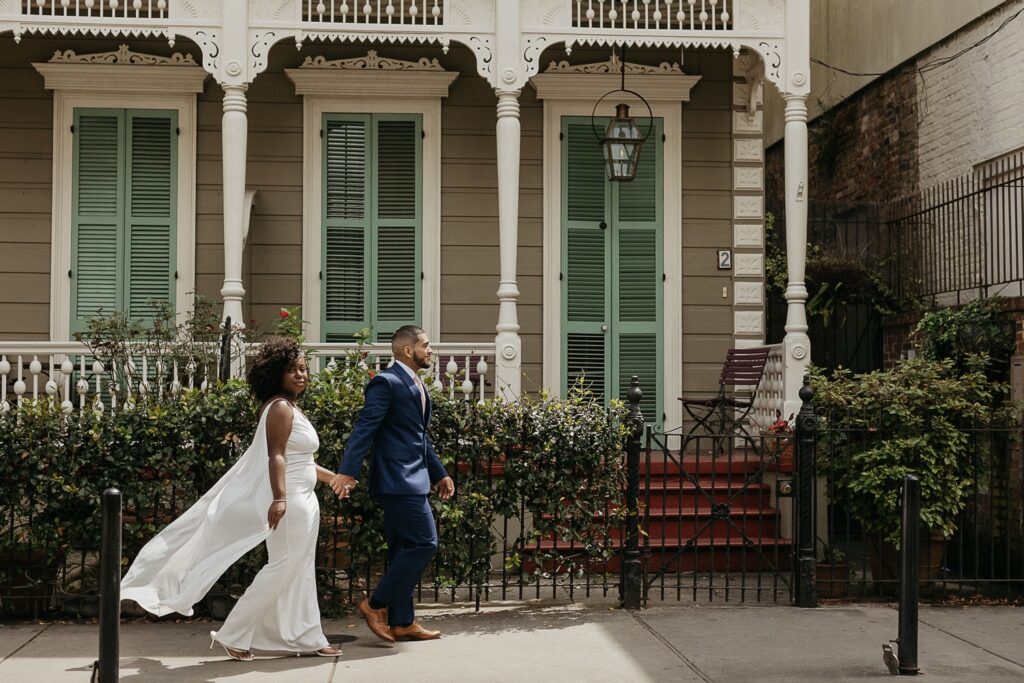 bride and groom elopement photo in French Quarter in front of colorful building