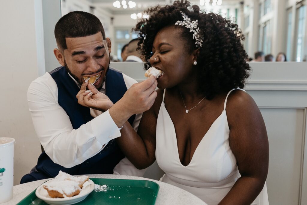 bride and groom elopement photo at Cafe Du Monde in New Orleans
