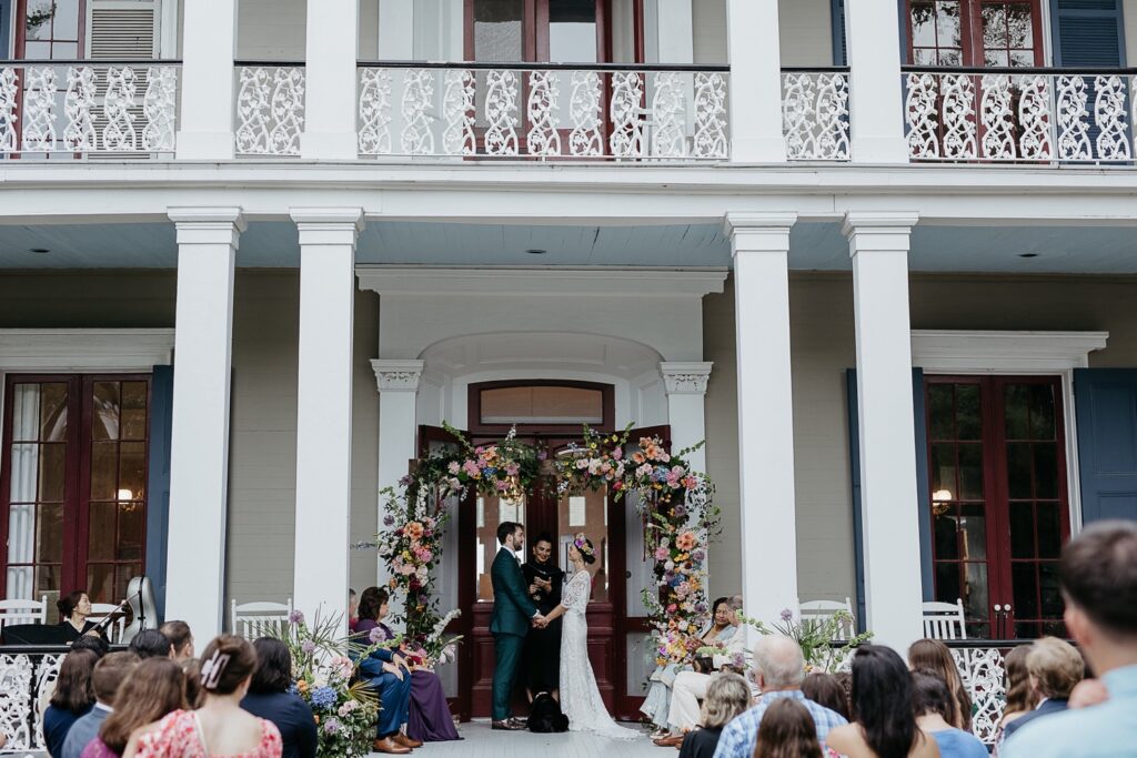 colorful wedding ceremony at derbes mansion with lush florals