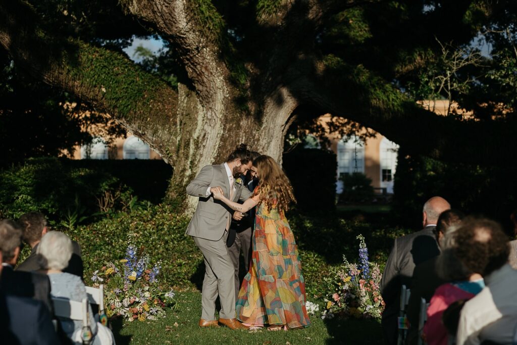 wedding ceremony in front of oak tree at new orleans city park botanical gardens