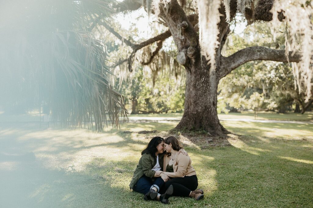 couple embracing under oak tree in new orleans city park