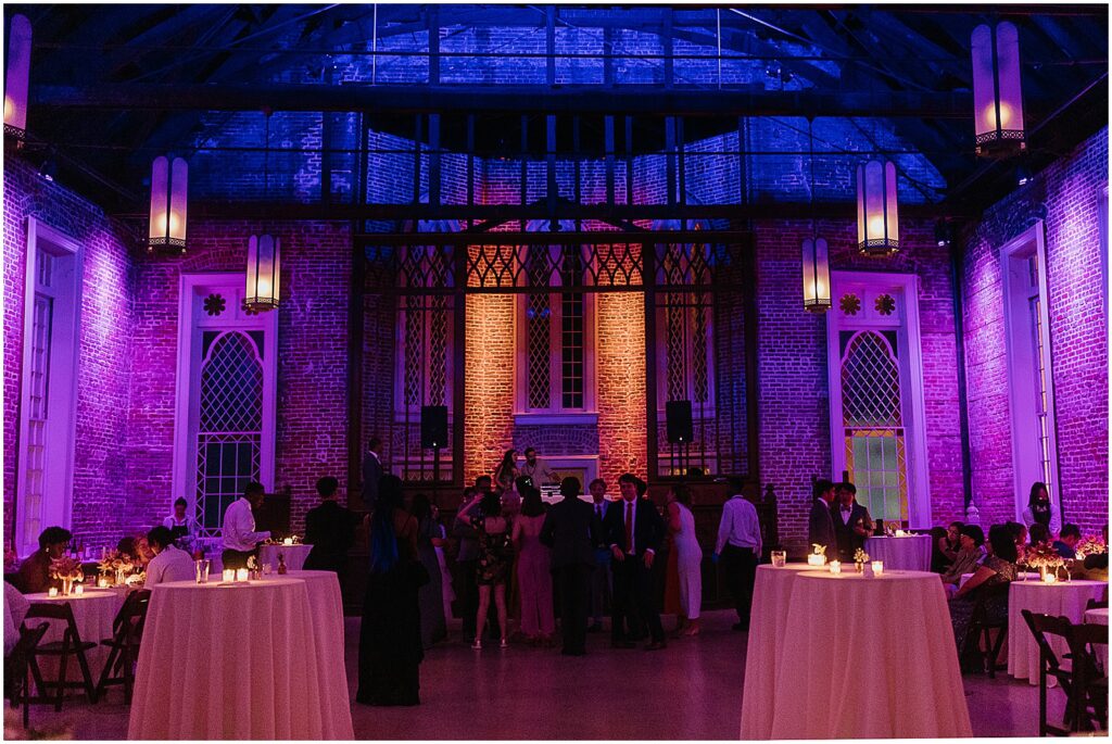 Guests gather for a wedding reception inside a New Orleans wedding venue.