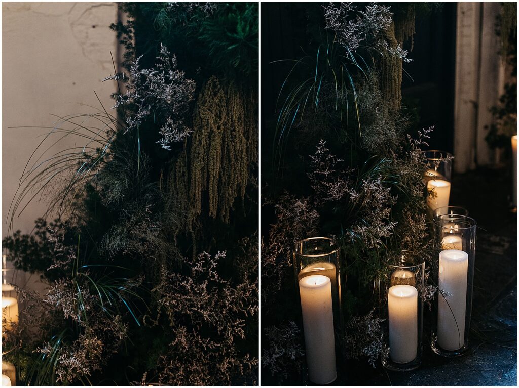 Pillar candles sit beside a floral installation with Spanish moss inside Latrobe's New Orleans.