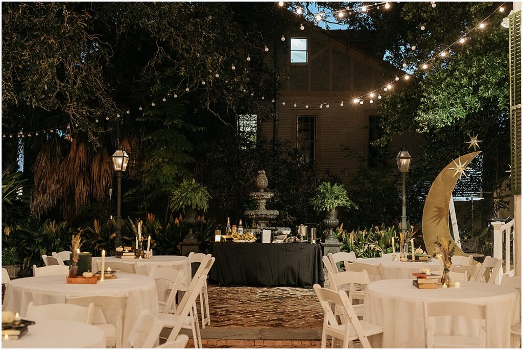 A courtyard is decorated for a nighttime reception at a New Orleans wedding venue.
