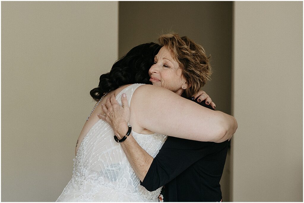 A bride hugs their mother in a New Orleans hotel.