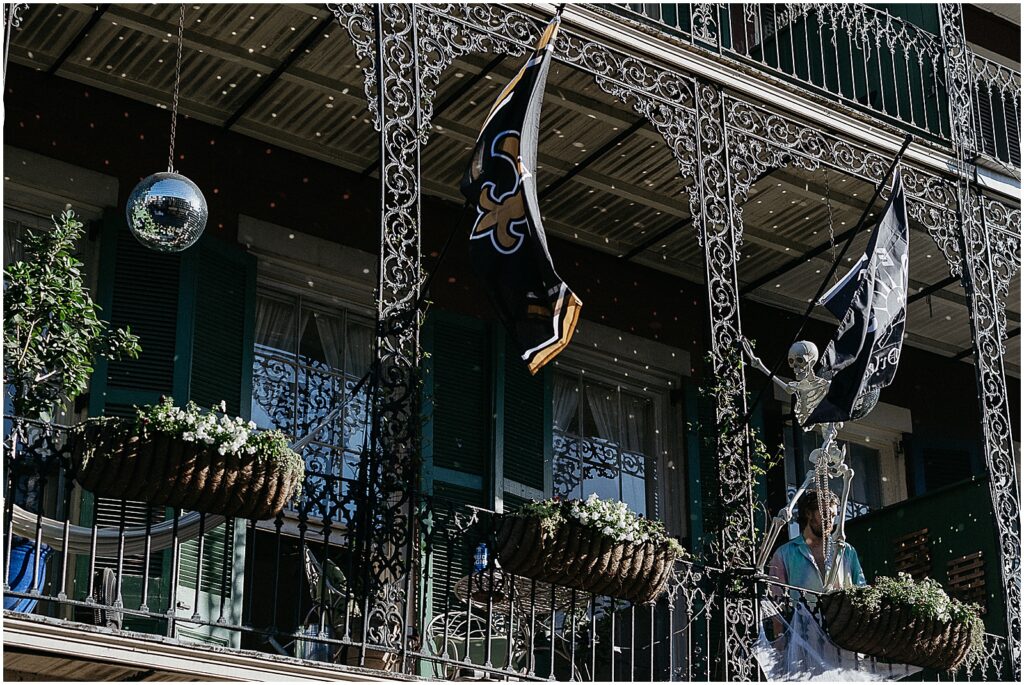 A disco ball hangs from a French Quarter balcony.